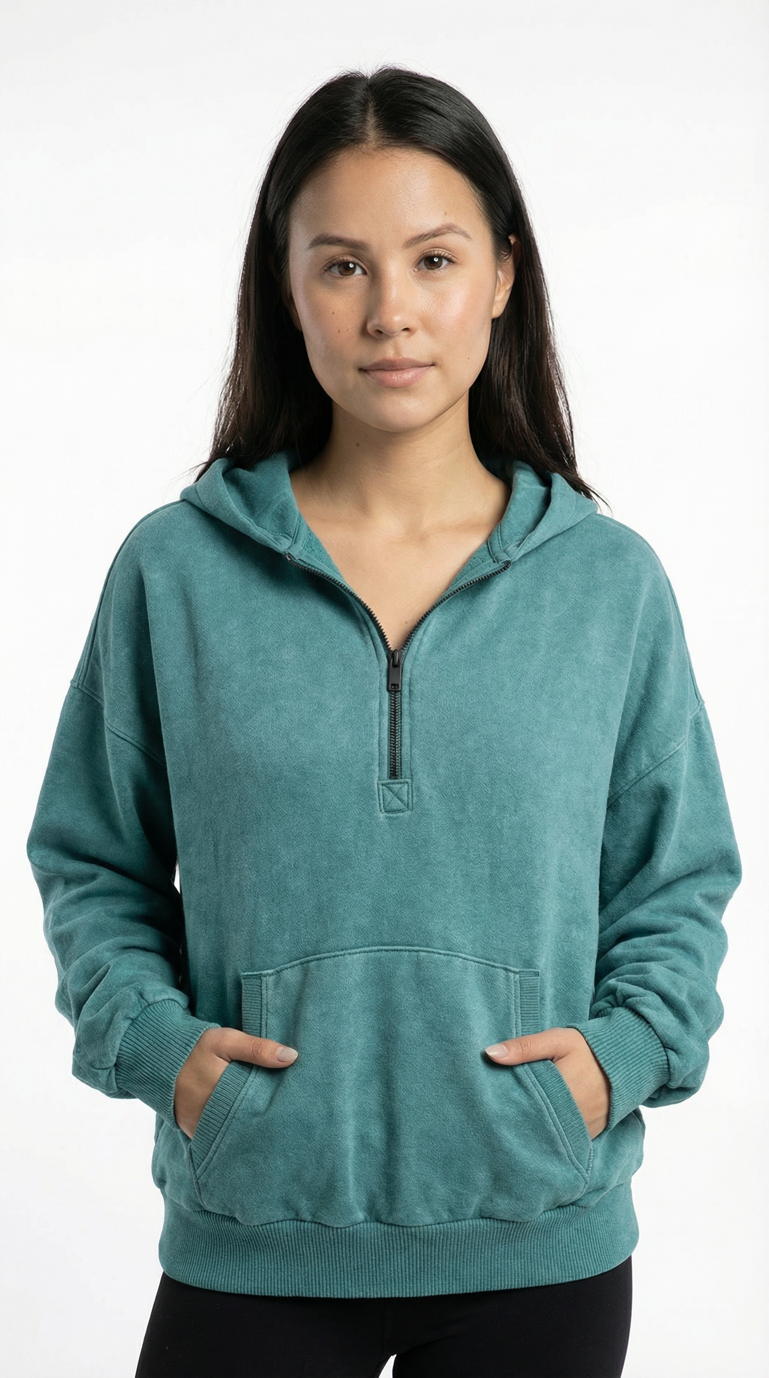 Woman wearing a teal hoodie with a white background