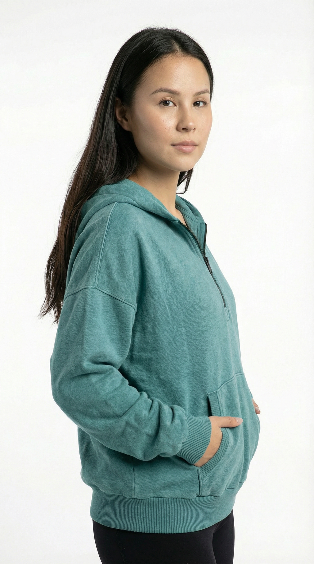 Woman wearing a teal hoodie on a white background
