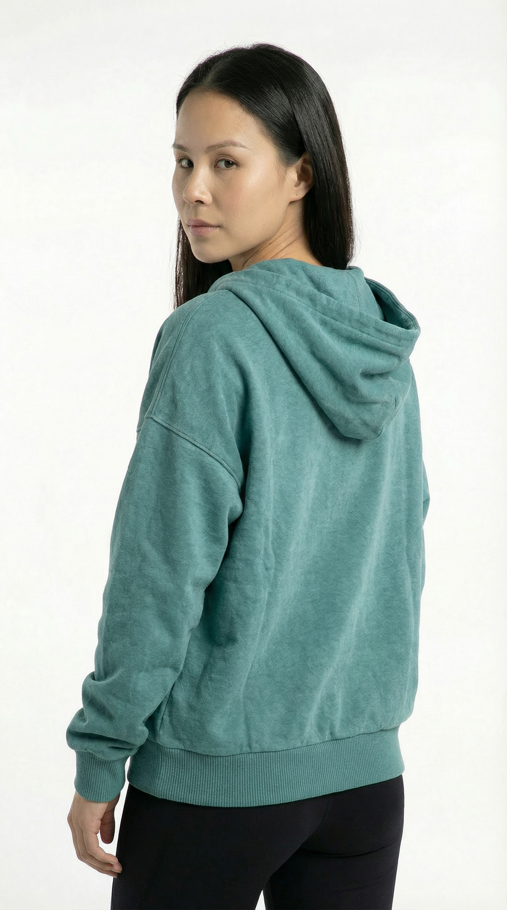 Person wearing a teal hoodie on a white background