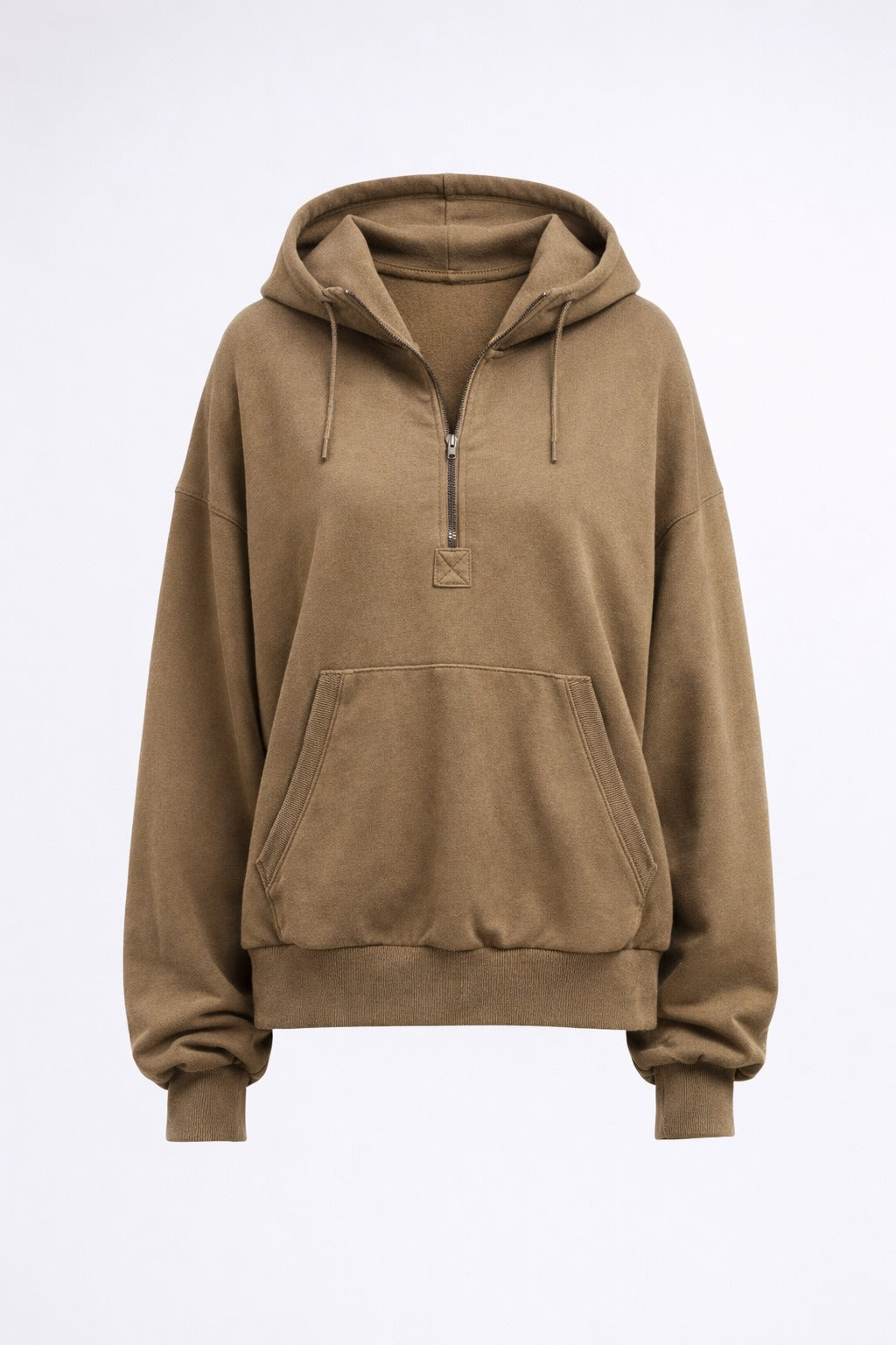 Woman in a beige hoodie holding a coffee cup against a textured wall