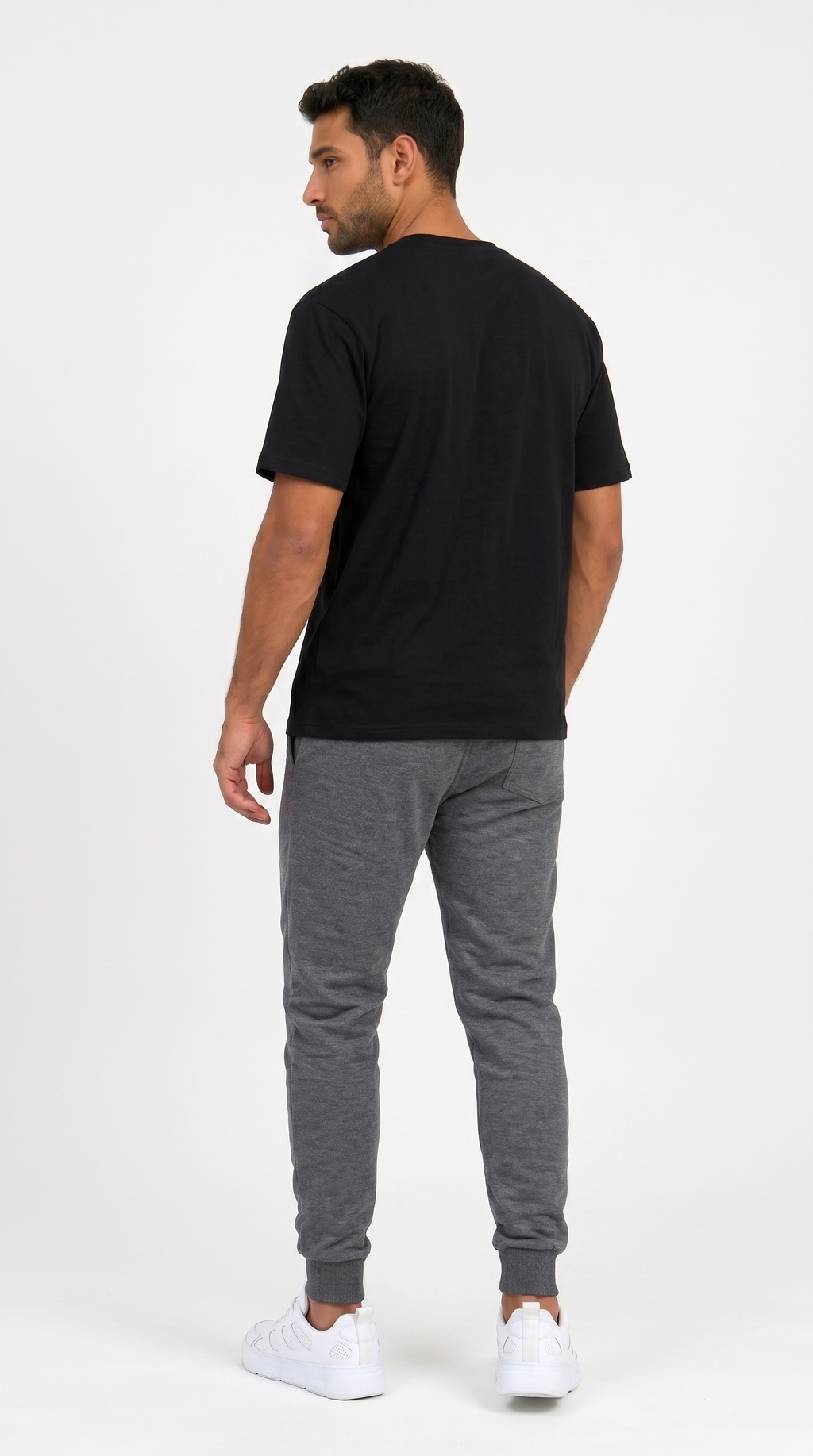 A man shown from the back wearing a black short-sleeve t-shirt, heather gray jogger pants, and white sneakers, standing against a plain white studio background, from Meleche Fashion USA or Meléche (short as (Mé))