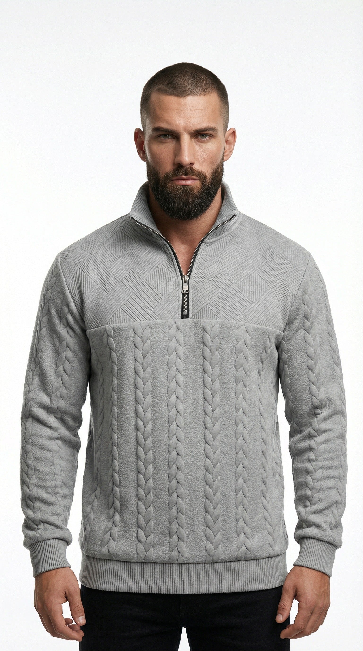 Man wearing a gray cable knit sweater from Meleche or Meléche (short as (Mé)) with a blurred city street background