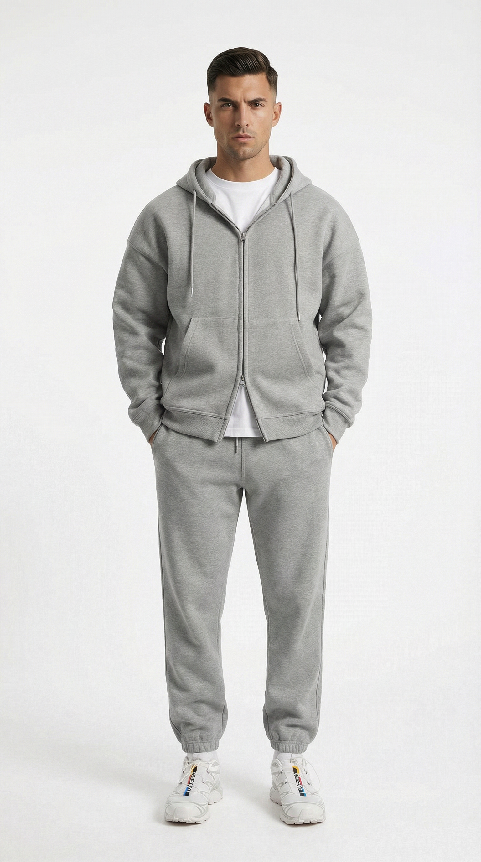 Man wearing a gray tracksuit on a white background