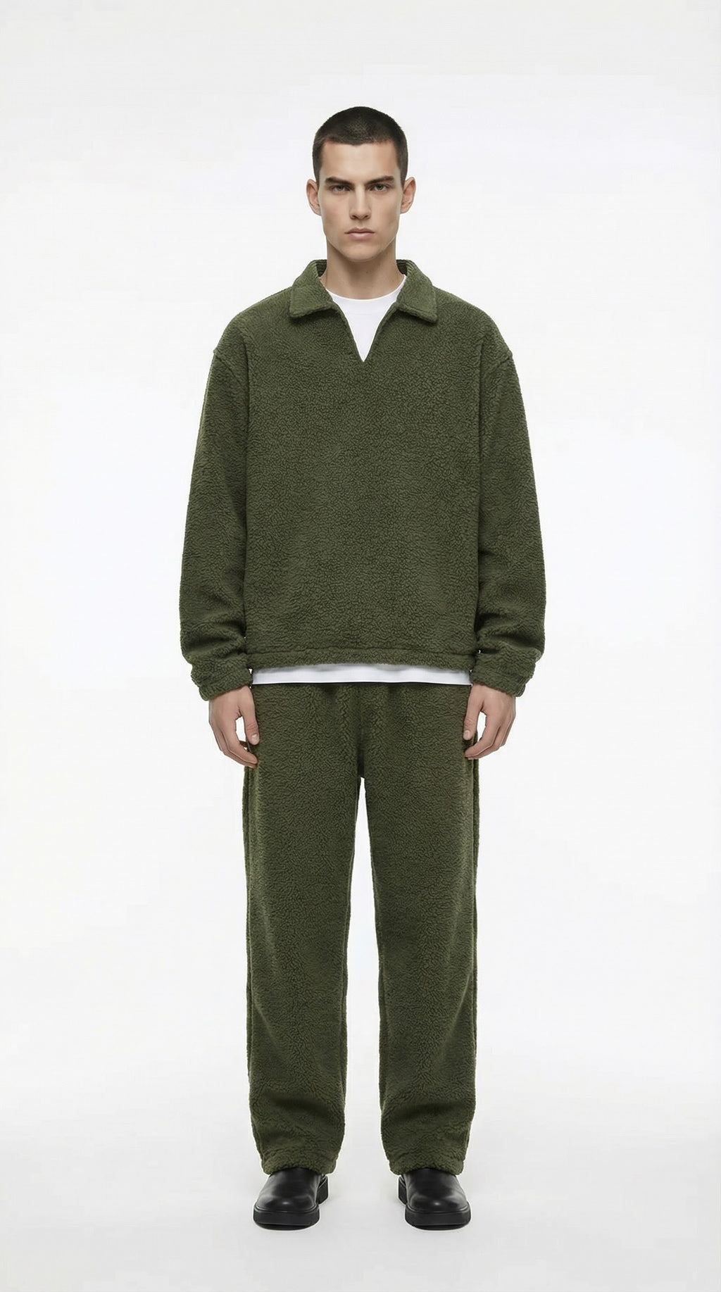 Man wearing a green fleece outfit on a white background