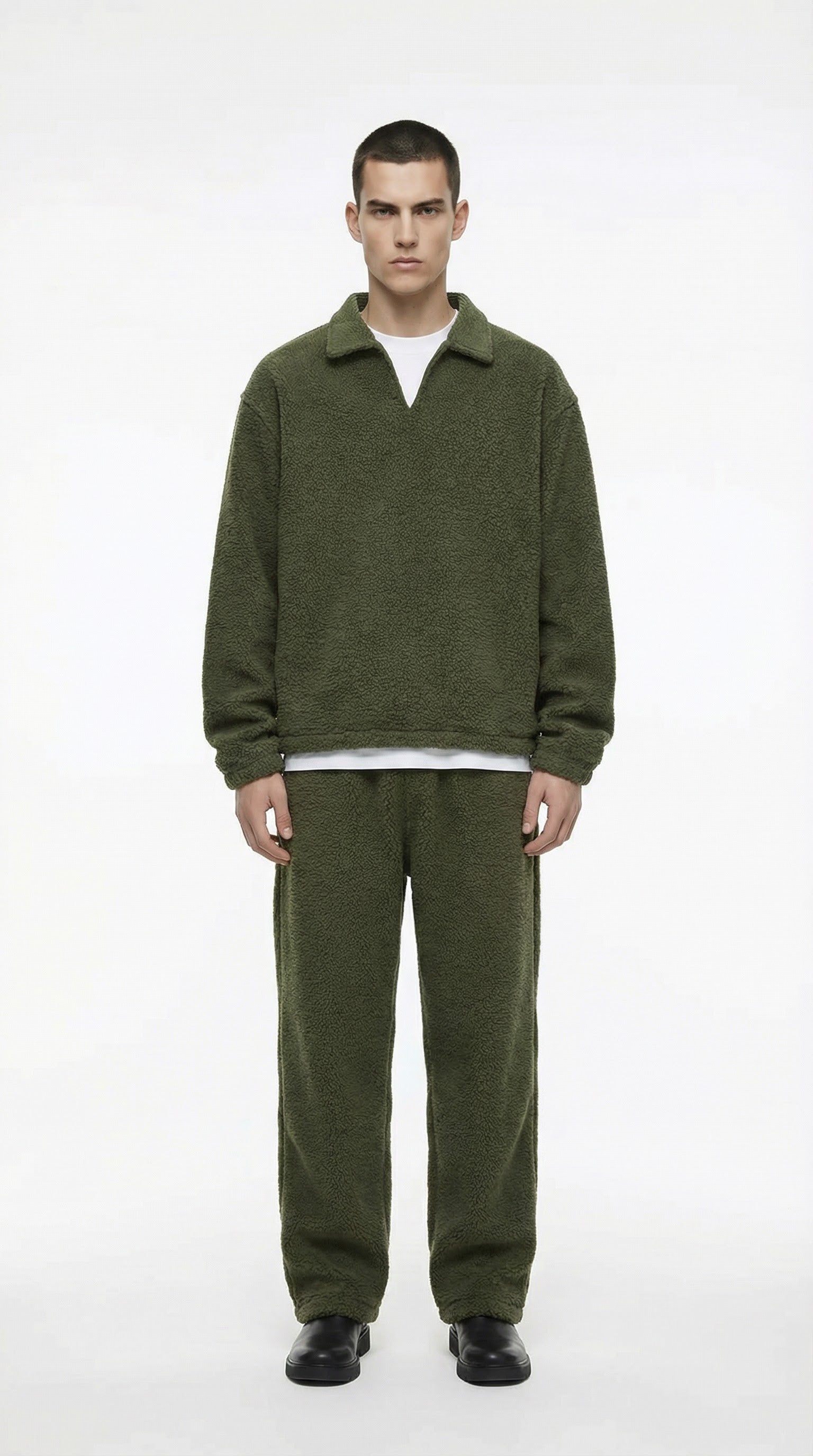 Man wearing a green fleece outfit on a white background