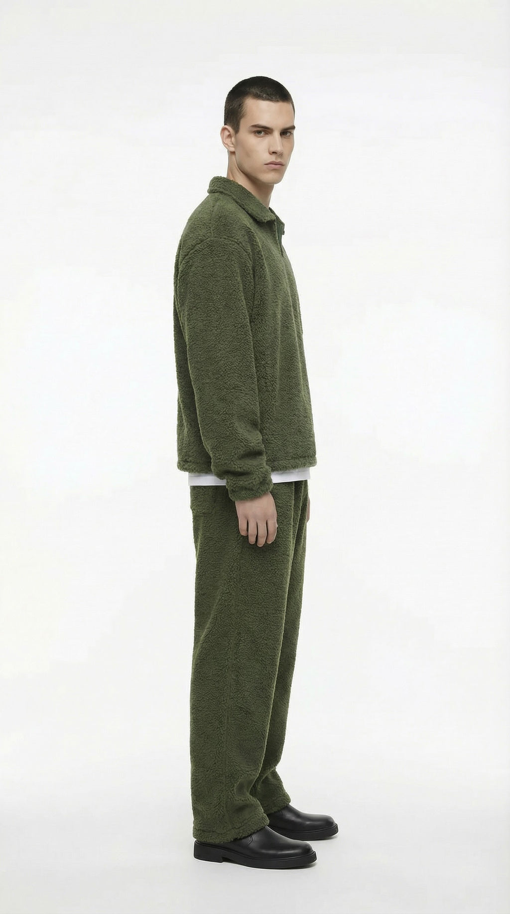 Man wearing a green tracksuit on a white background