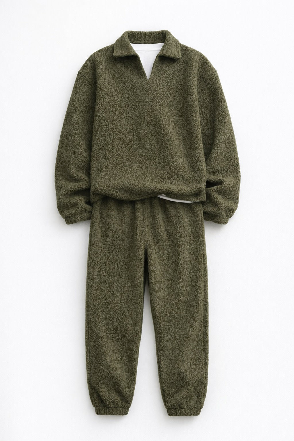 Green sweater and pants set on a white background
