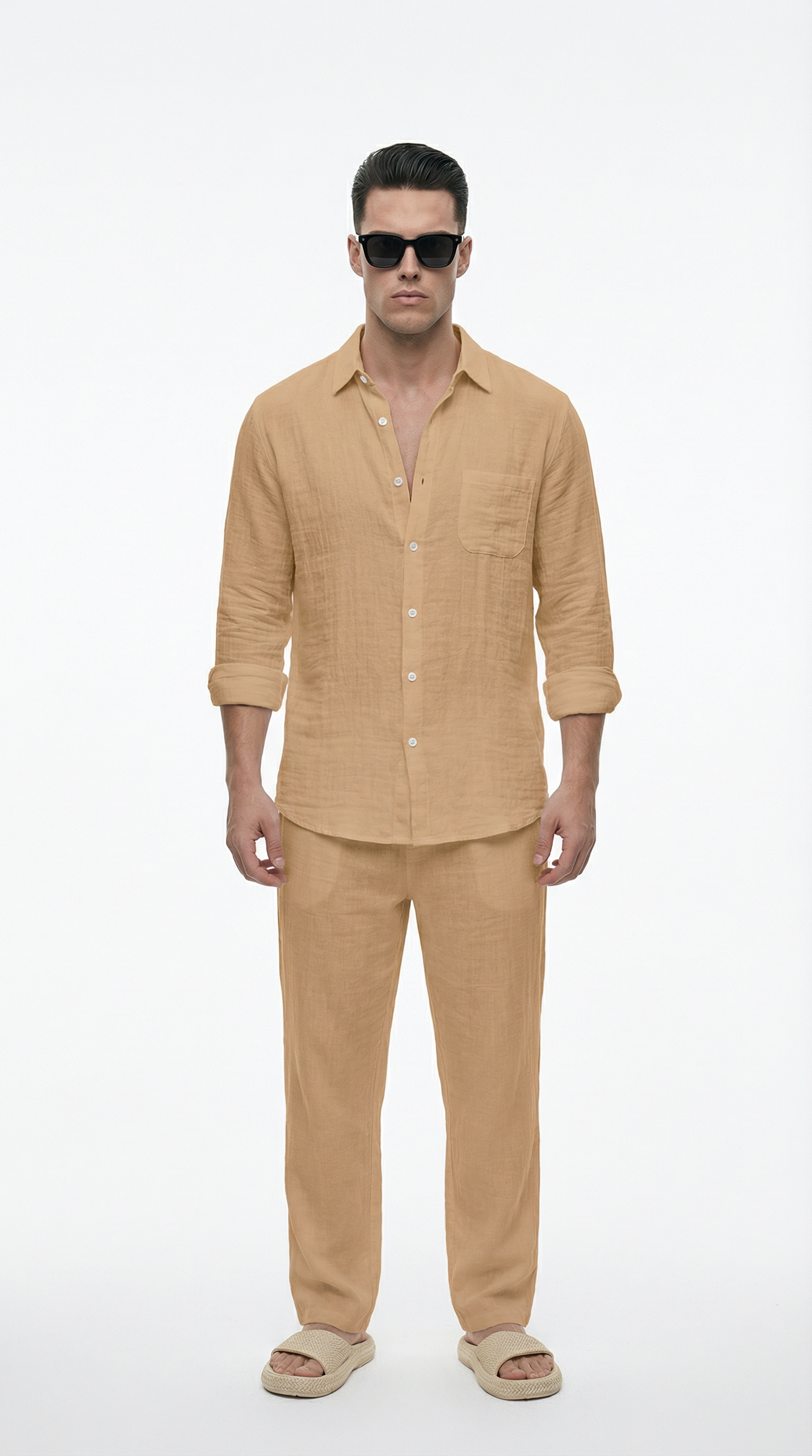 Man wearing a beige shirt and pants with sunglasses on a white background