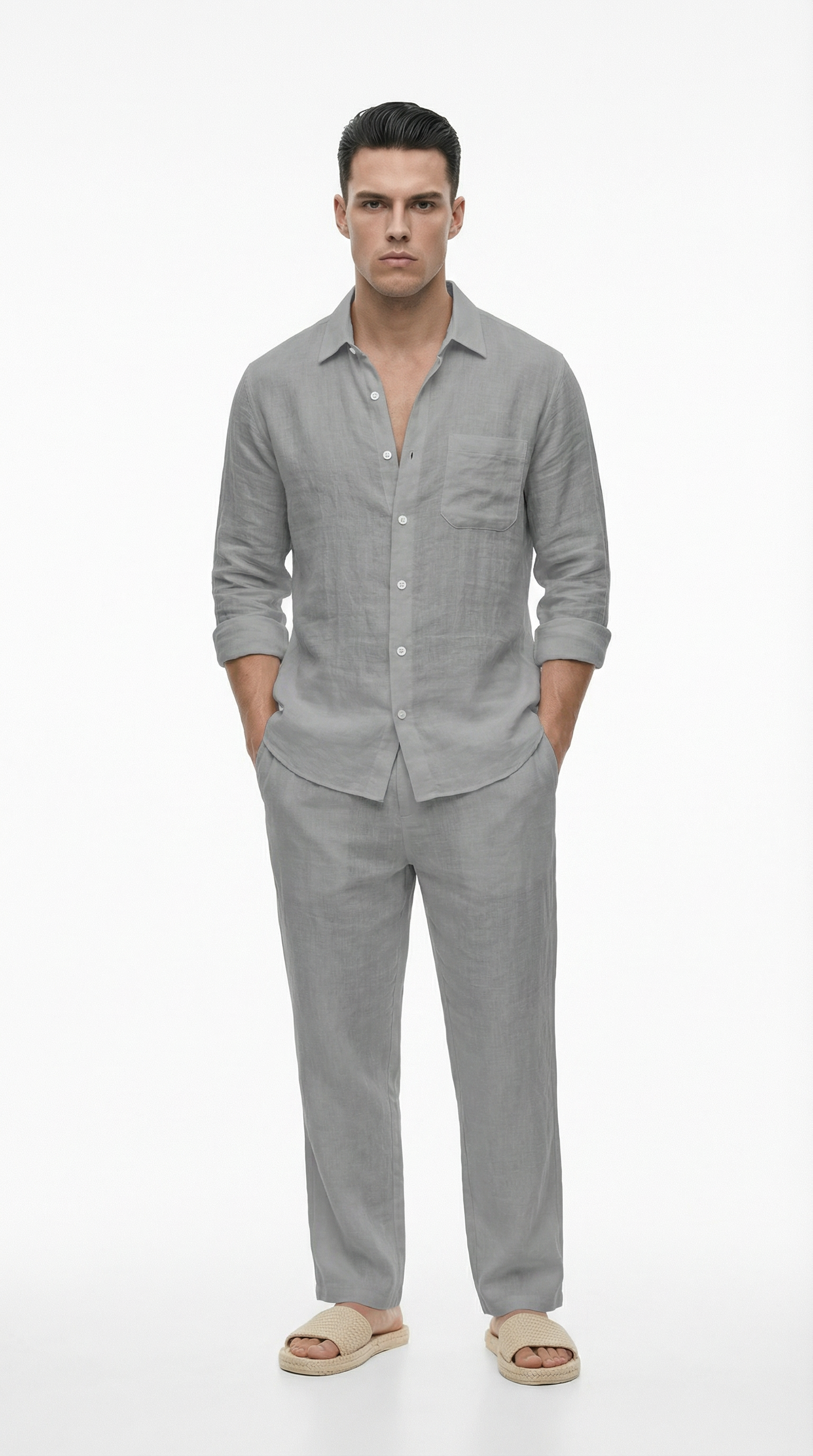 Man wearing a gray linen shirt and pants on a white background