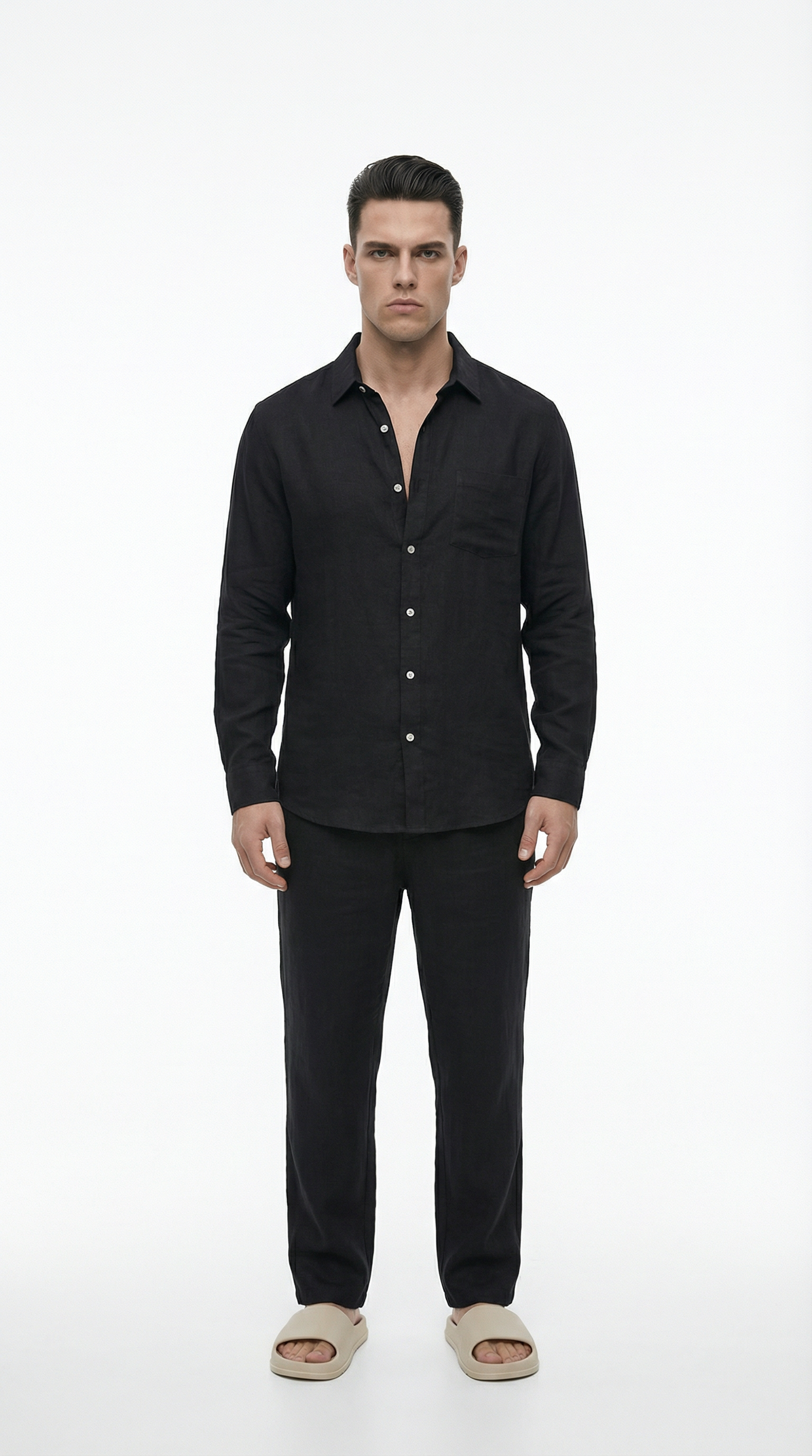 Man wearing a black shirt and pants on a white background