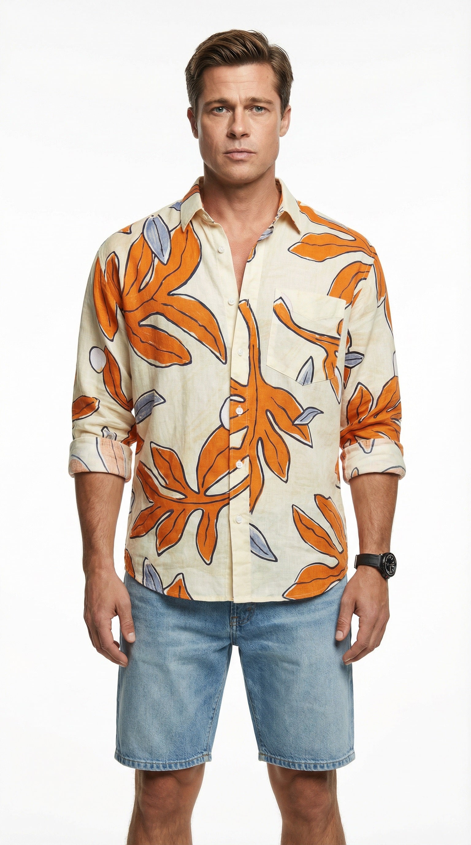 Person wearing a patterned shirt and denim shorts sitting on a couch.