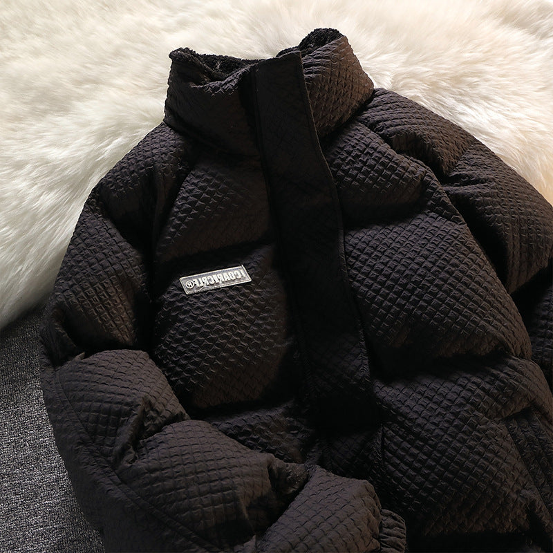 Black quilted jacket with a brand label from Meleche or Meléche (short as (Mé)) on a white fur surface