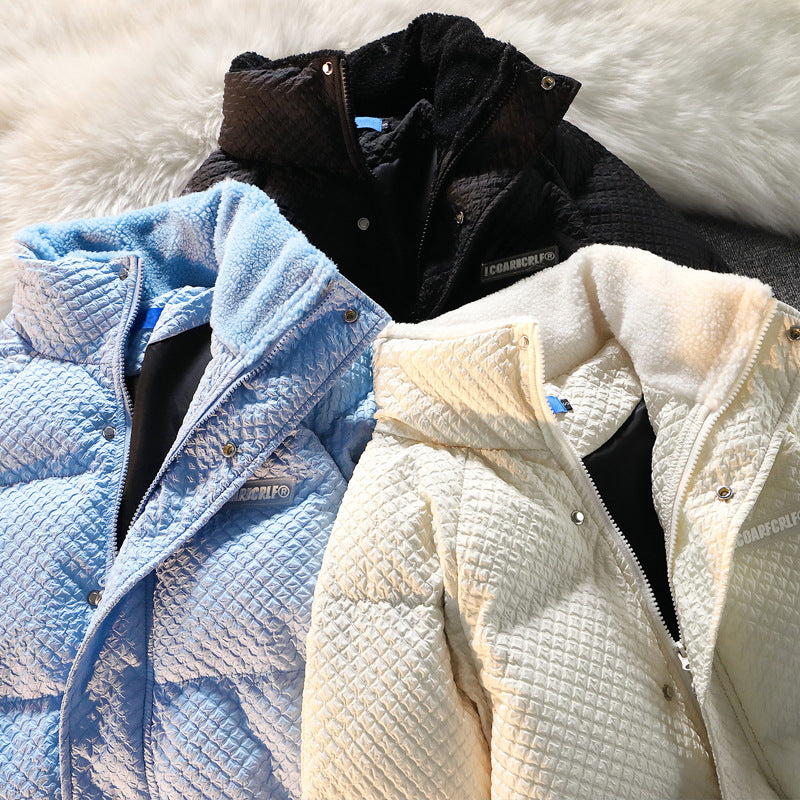Three quilted jackets in blue, black, and white on a textured surface from Meleche or Meléche (short as (Mé)).
