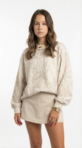 Woman wearing a beige sweater and skirt set on a white background