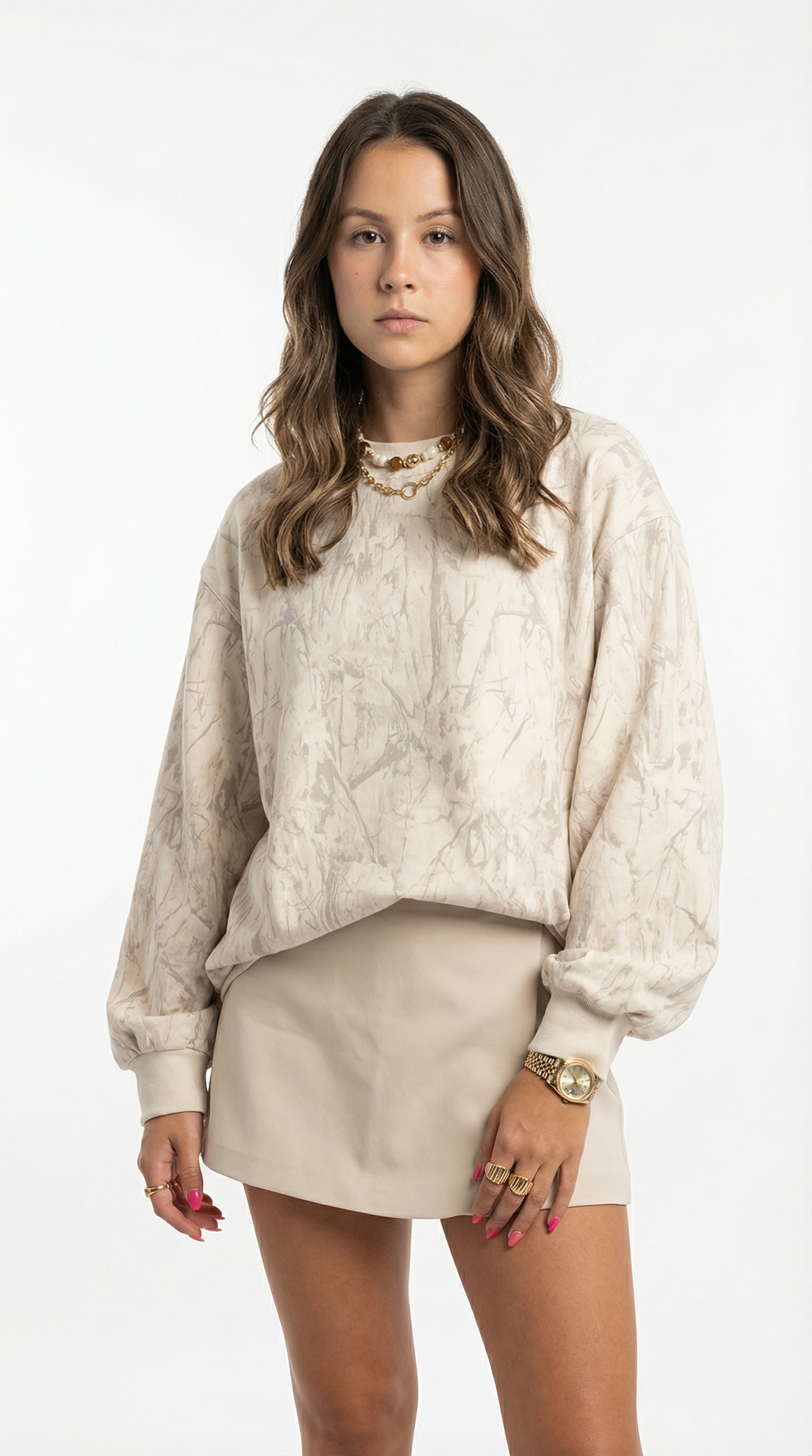 Woman wearing a beige sweater and skirt set on a white background
