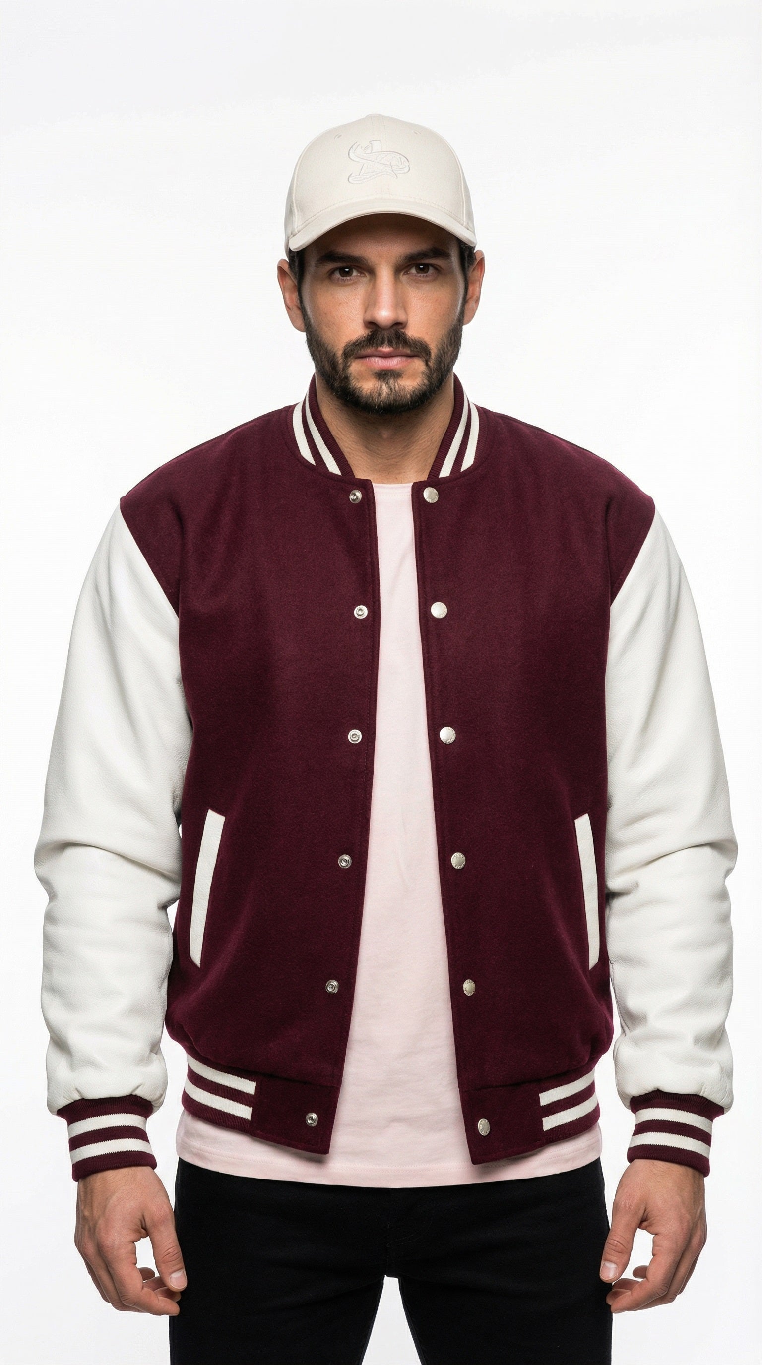 Man wearing a maroon and white varsity jacket with gray pants from Meleche or Meléche (short as (Mé)), standing against a gray wall.