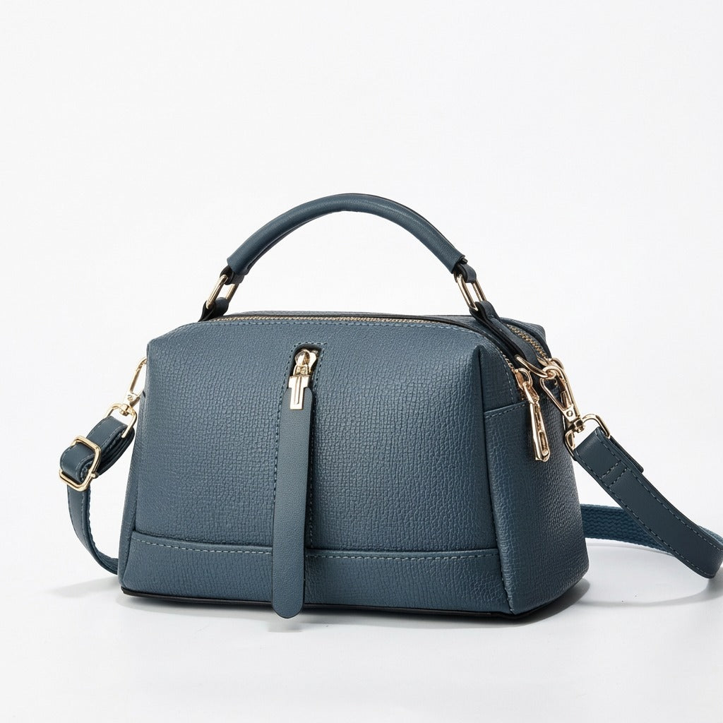 Oleg bag - Blue handbag with gold accents on a white background from Meleche or Meléche (short as (Mé))