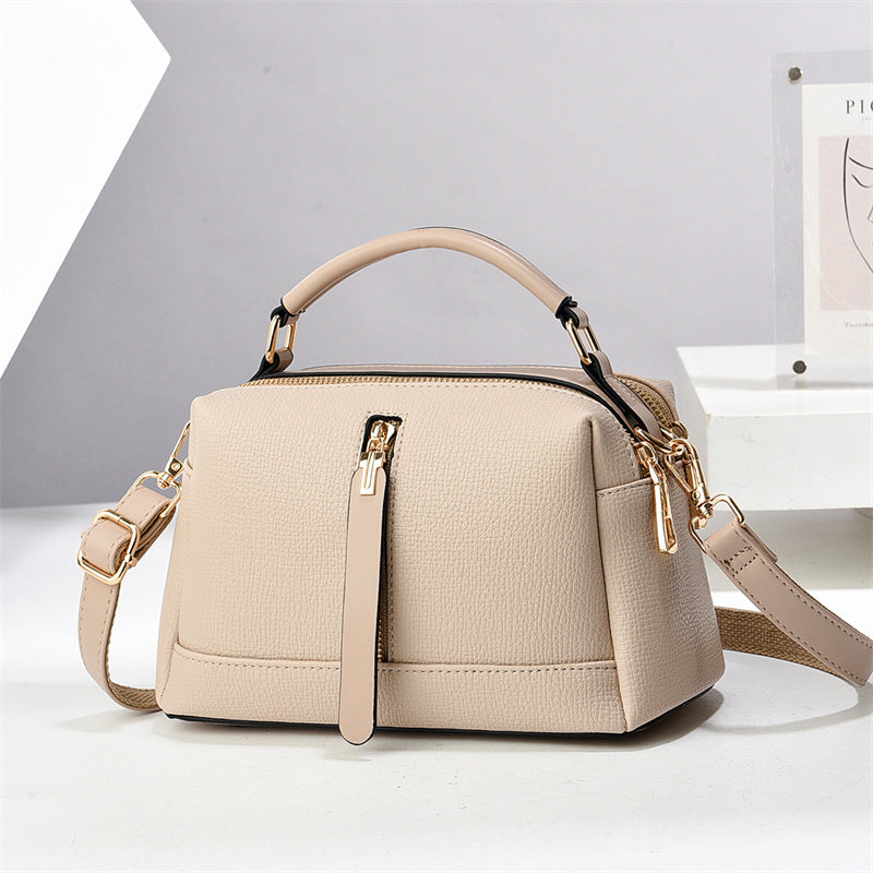 Oleg bag - Beige handbag with a strap on a light gray background