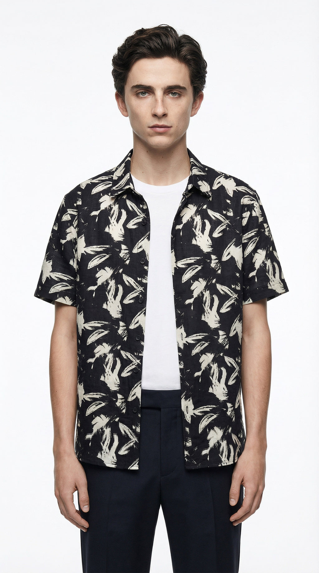Black and white patterned shirt on a hanger against a white background