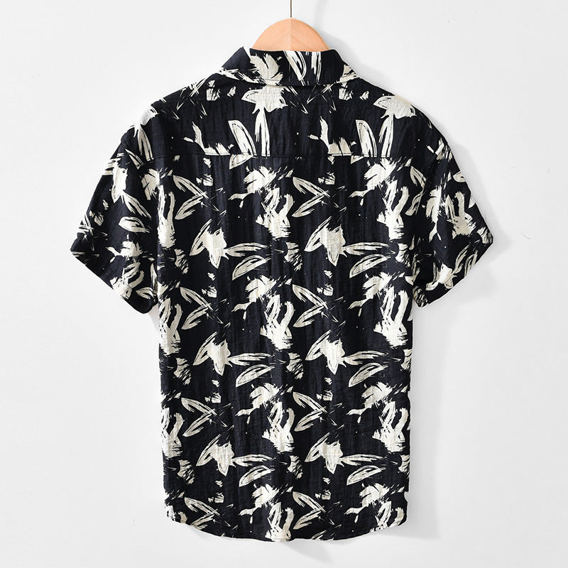 Black shirt with white abstract pattern on a hanger against a white background