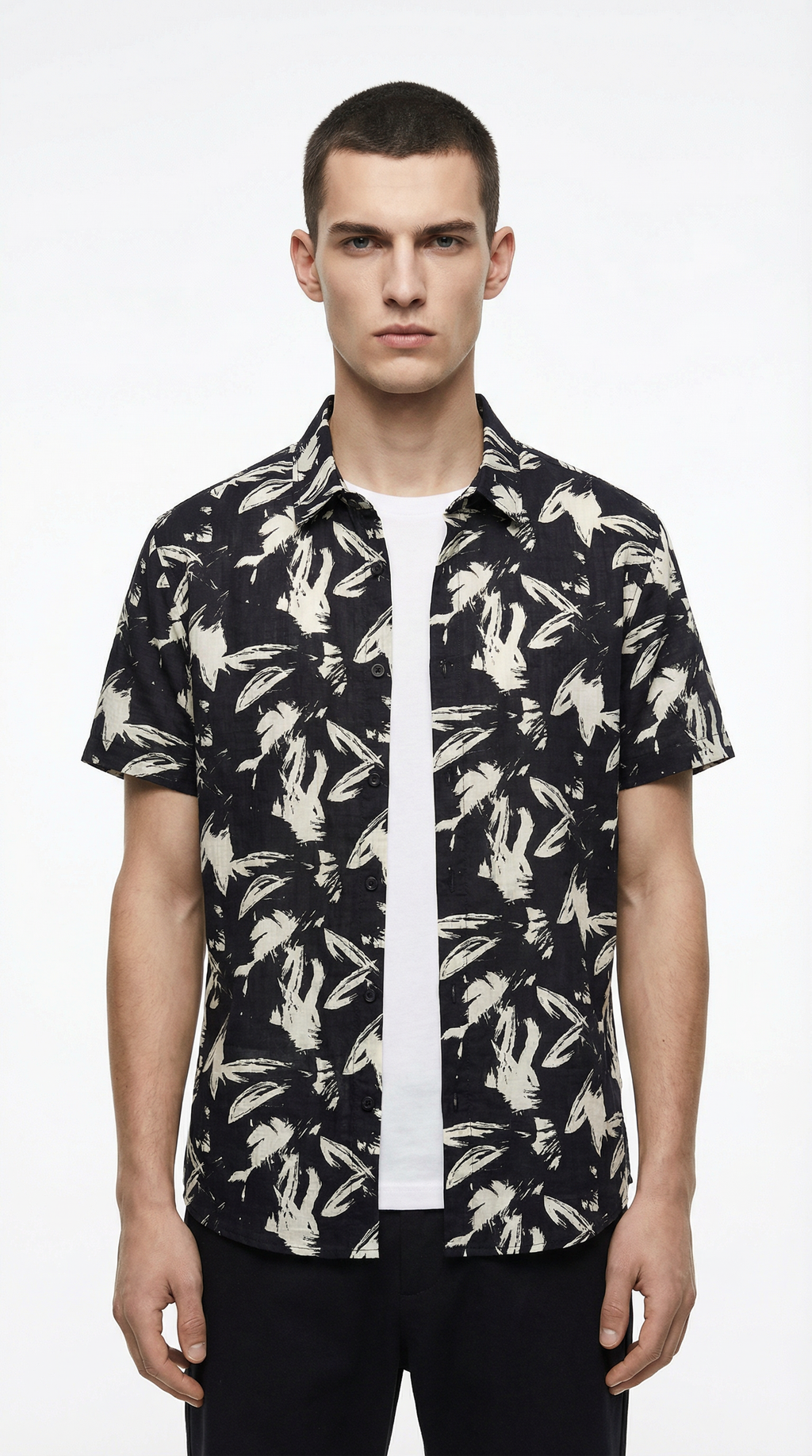 Man wearing a black floral patterned shirt from Meleche or Meléche (short as (Mé))