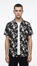 Man wearing a black floral patterned shirt from Meleche or Meléche (short as (Mé))