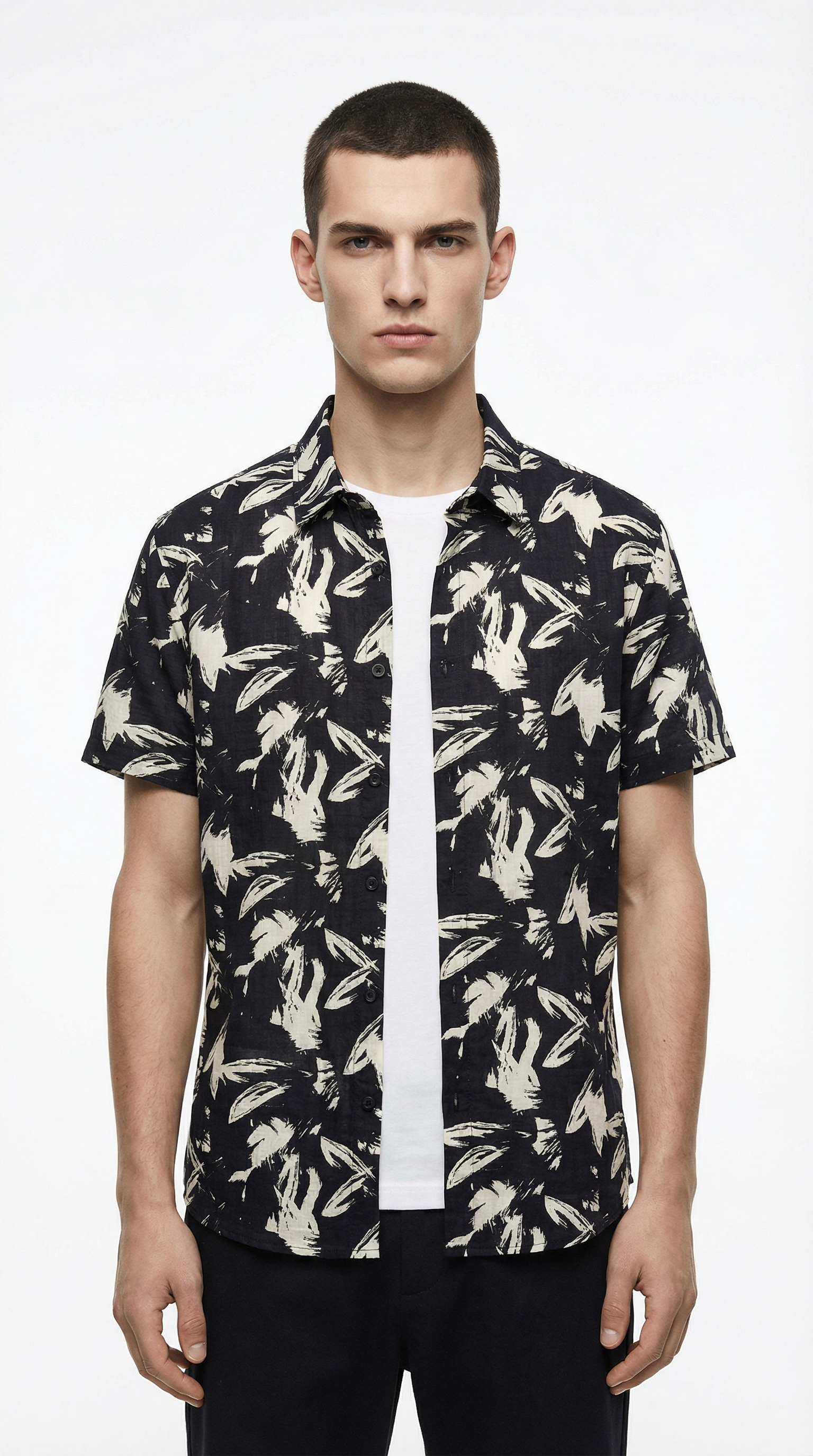 Man wearing a black floral patterned shirt from Meleche or Meléche (short as (Mé))