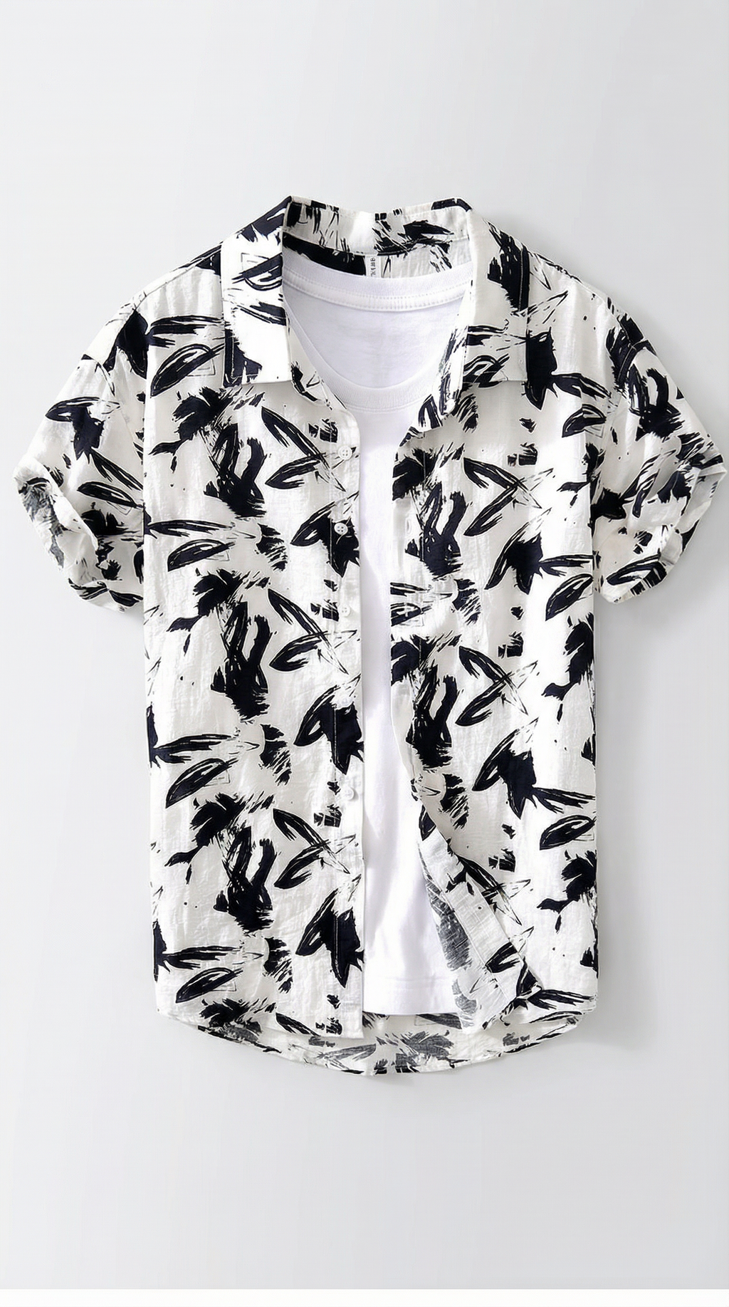 White shirt with black leaf pattern on a white background