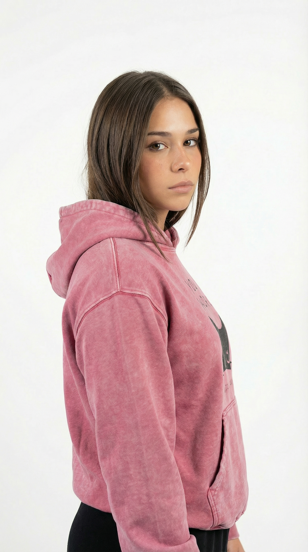 Person wearing a pink hoodie on a white background