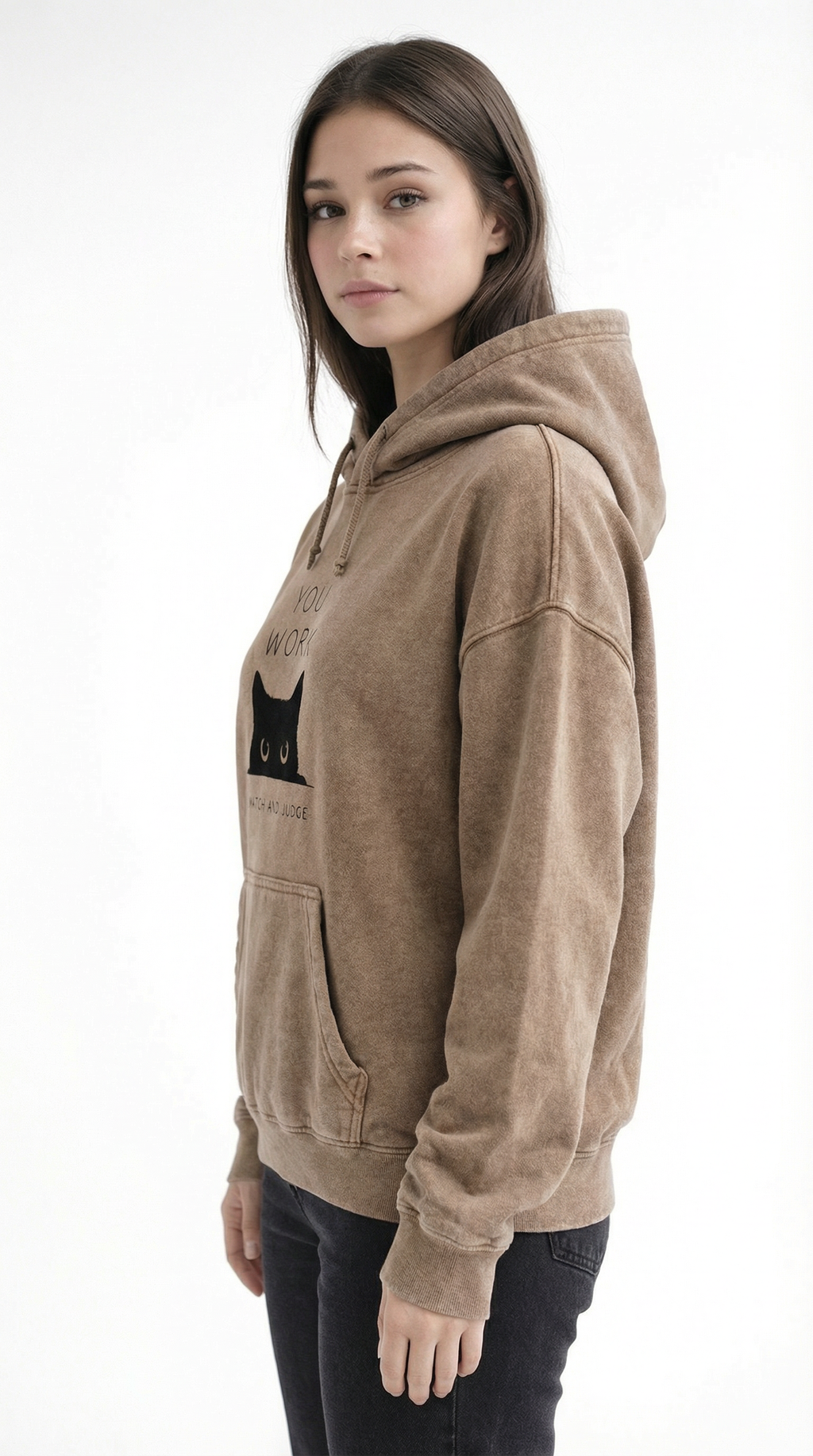 Woman wearing a beige hoodie with a black cat graphic on a white background