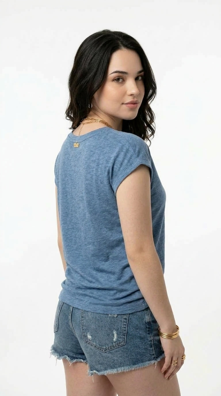 A woman wearing a heathered blue short-sleeve t-shirt and denim shorts, shown from a three-quarters back view against a plain white background, from Meleche Fashion USA or Meléche (short as (Mé))