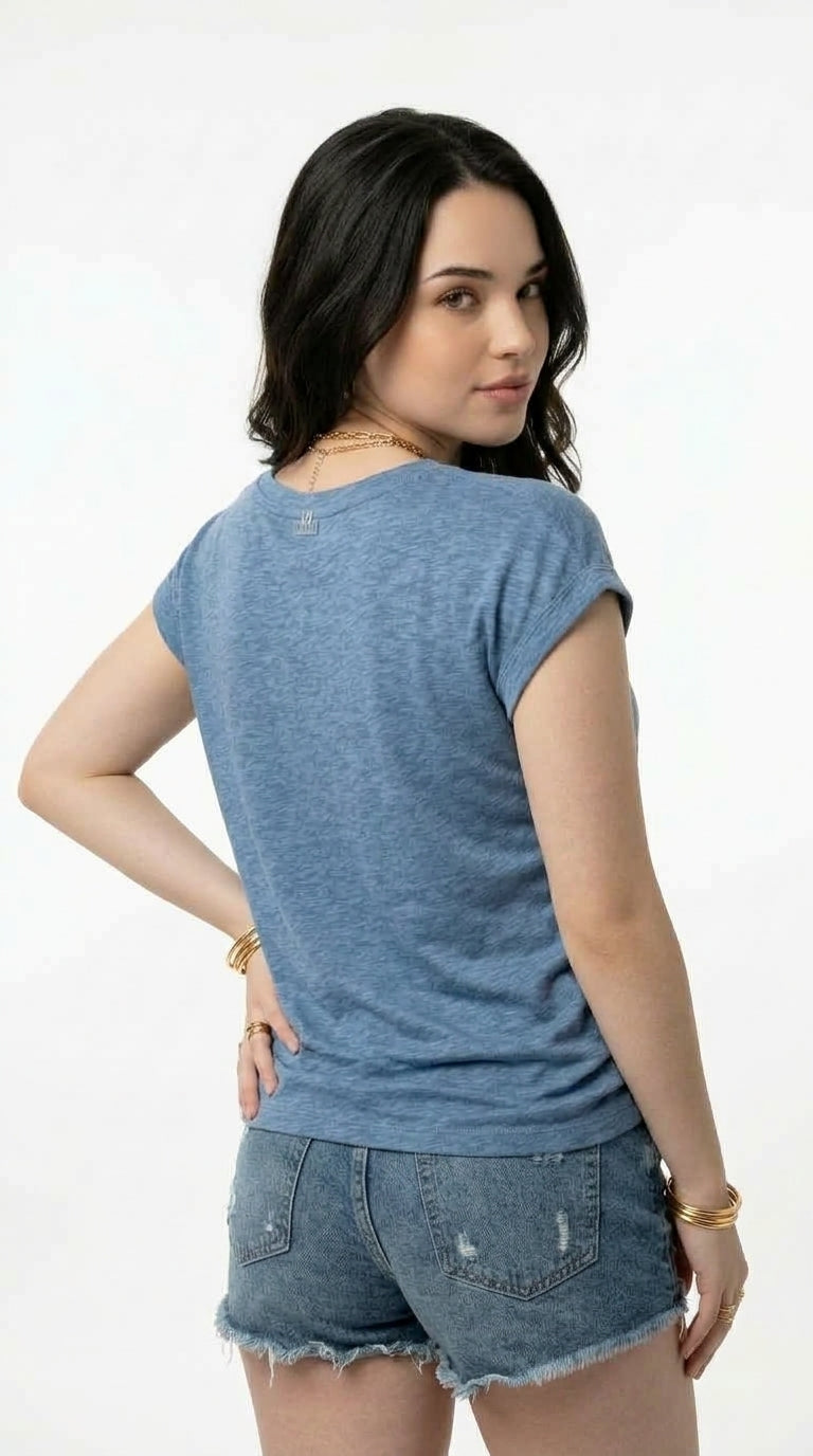 A woman wearing a heathered blue short-sleeve t-shirt and distressed denim shorts, shown from the back against a plain white background, from Meleche Fashion USA or Meléche (short as (Mé))