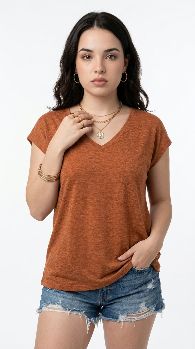 A woman modeling a short-sleeve V-neck t-shirt in a heathered burnt orange color, paired with distressed denim shorts, against a plain white studio background, from Meleche Fashion USA or Meléche (short as (Mé))