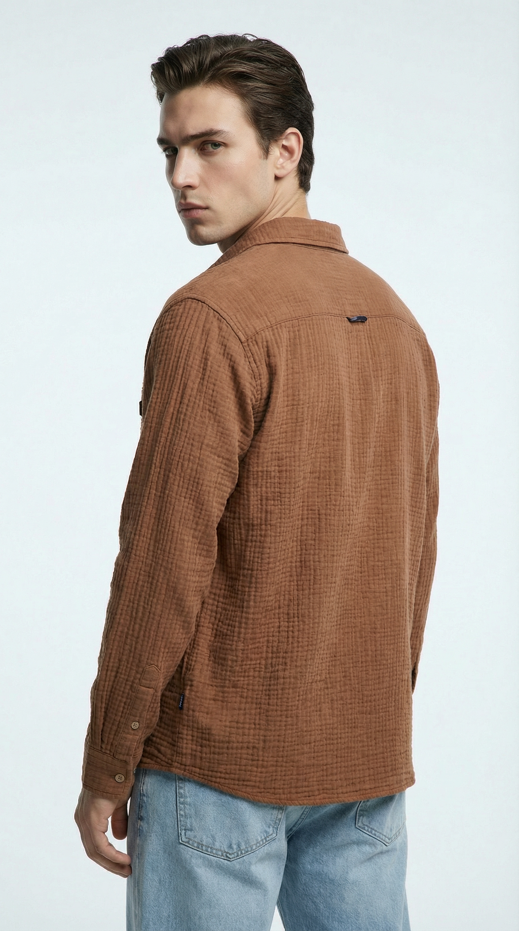 Man wearing a gray hoodie and pants on a white background