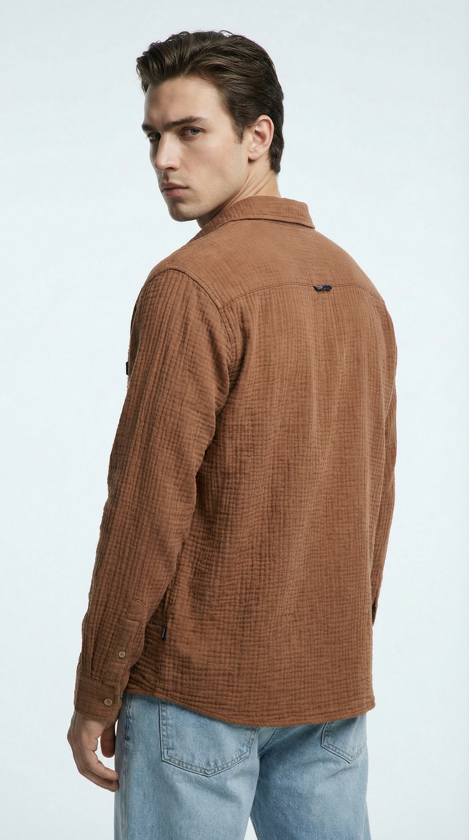 Man wearing a gray hoodie and pants on a white background