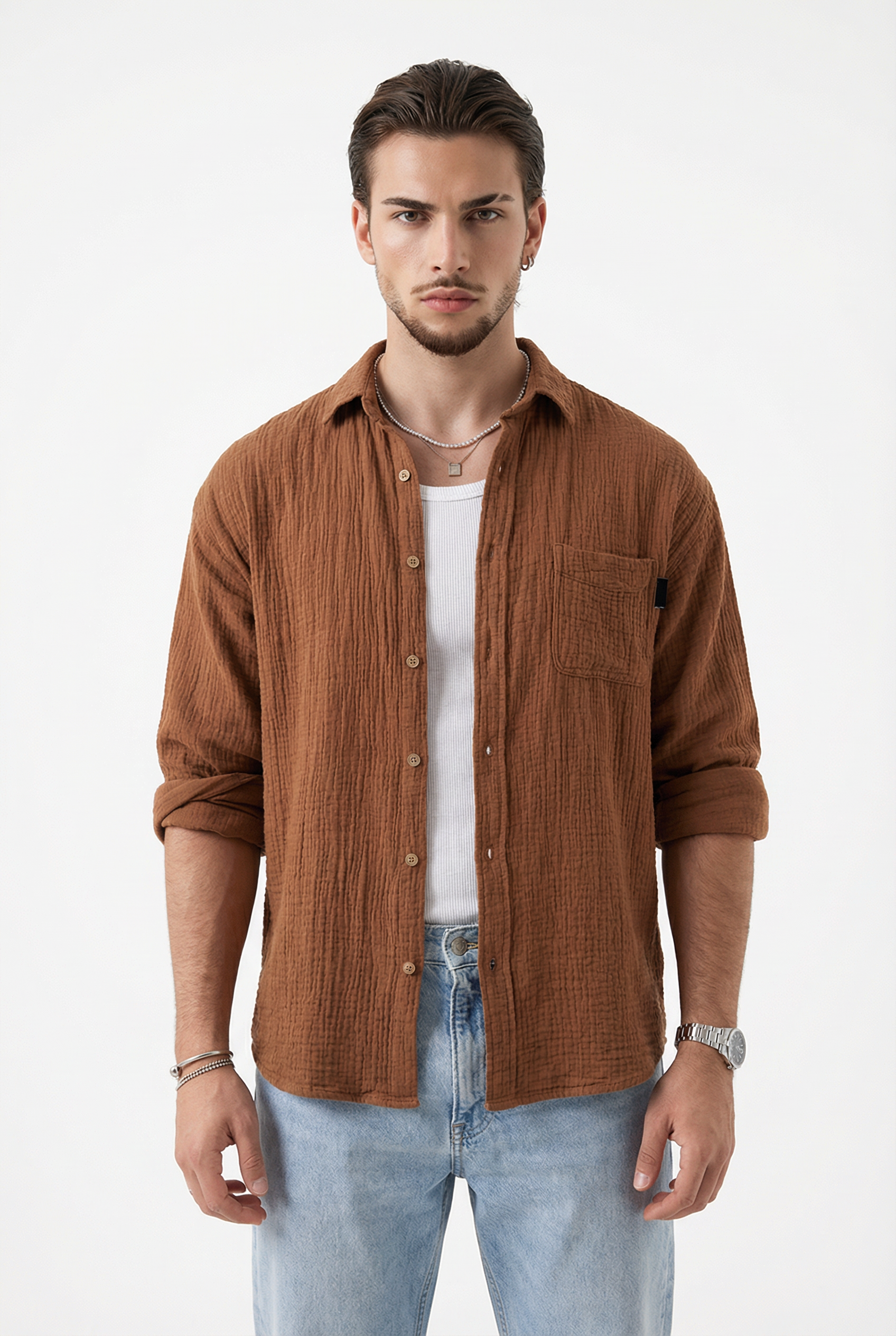 Man wearing a brown corduroy shirt over a white t-shirt with light blue jeans from Meleche or Meléche (short as (Mé))