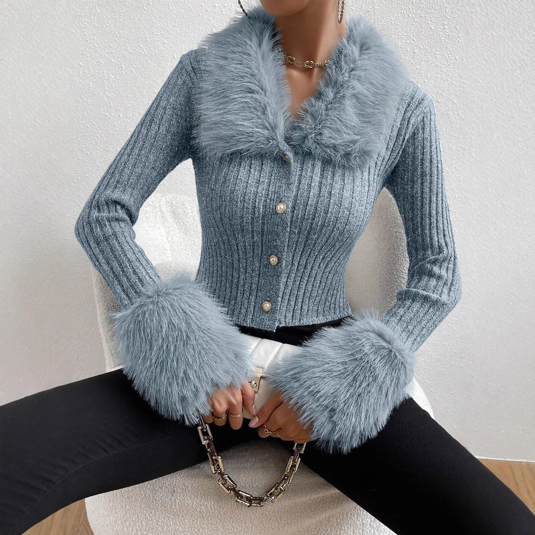 Blue knitted cardigan with fur cuffs and collar worn by a person.