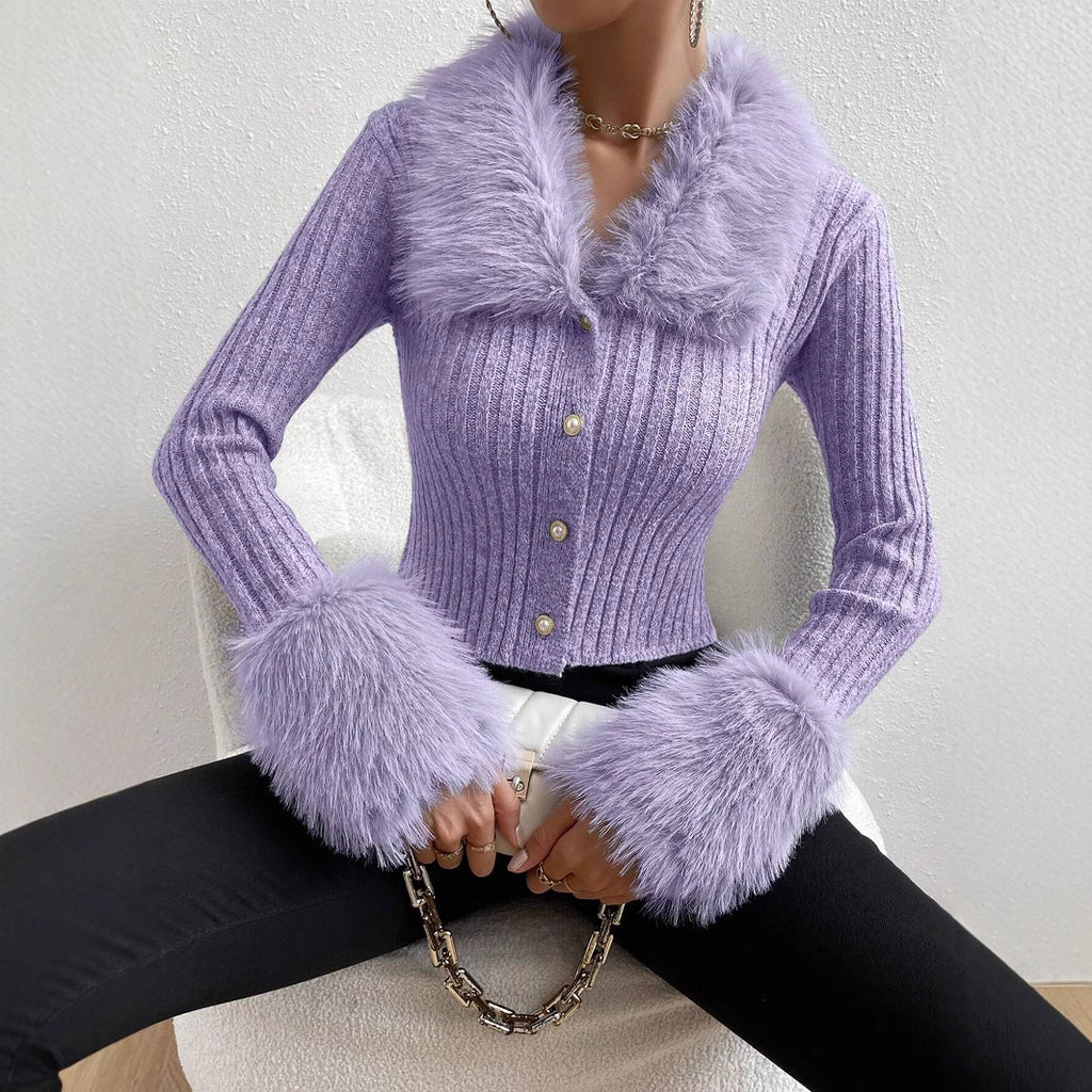Purple knitted cardigan with fur trim worn by a person on a white background