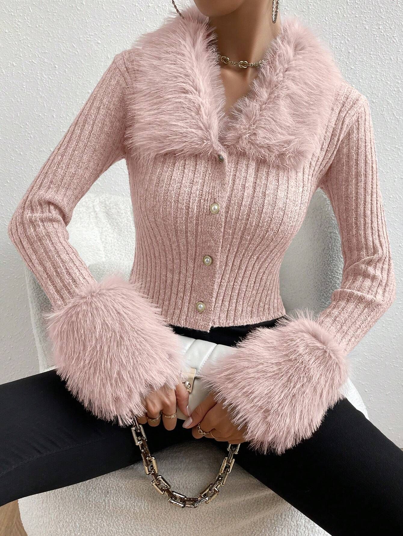 Pink knitted cardigan with fluffy cuffs and collar on a neutral background