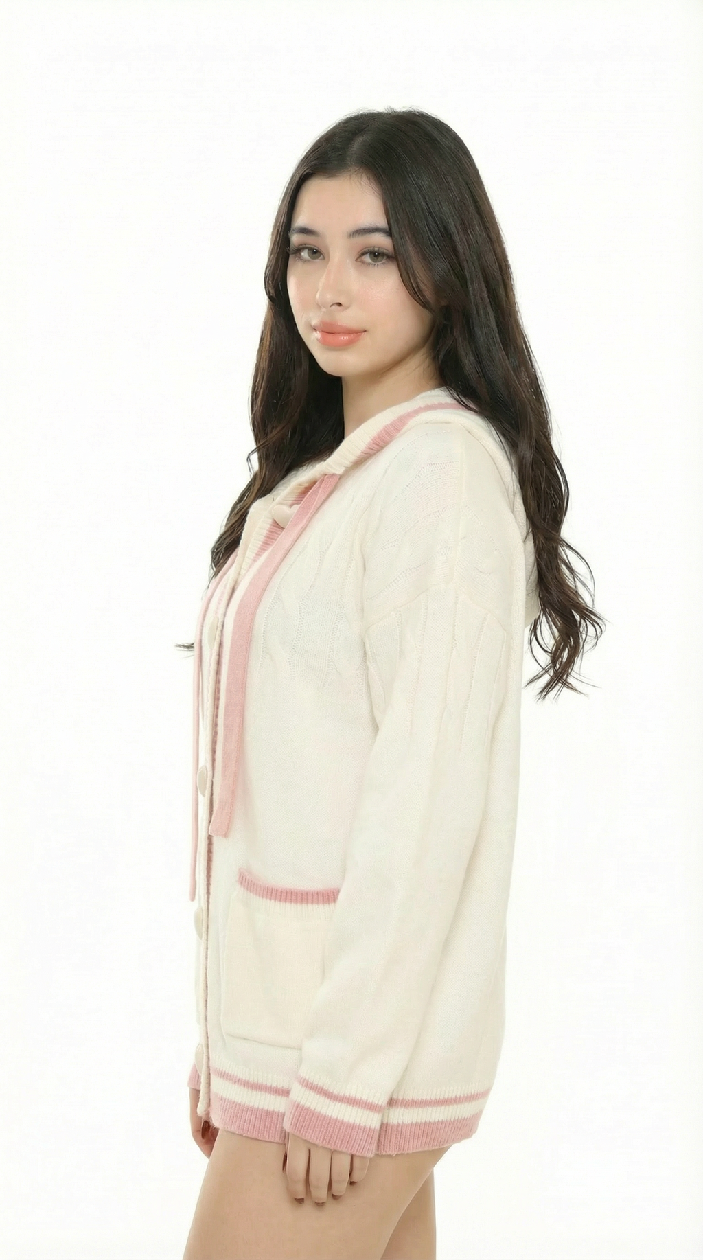 Women wearing a cream cardigan with  sexy pink trim from Meleche or Meléche (short as (Mé)) on a white background