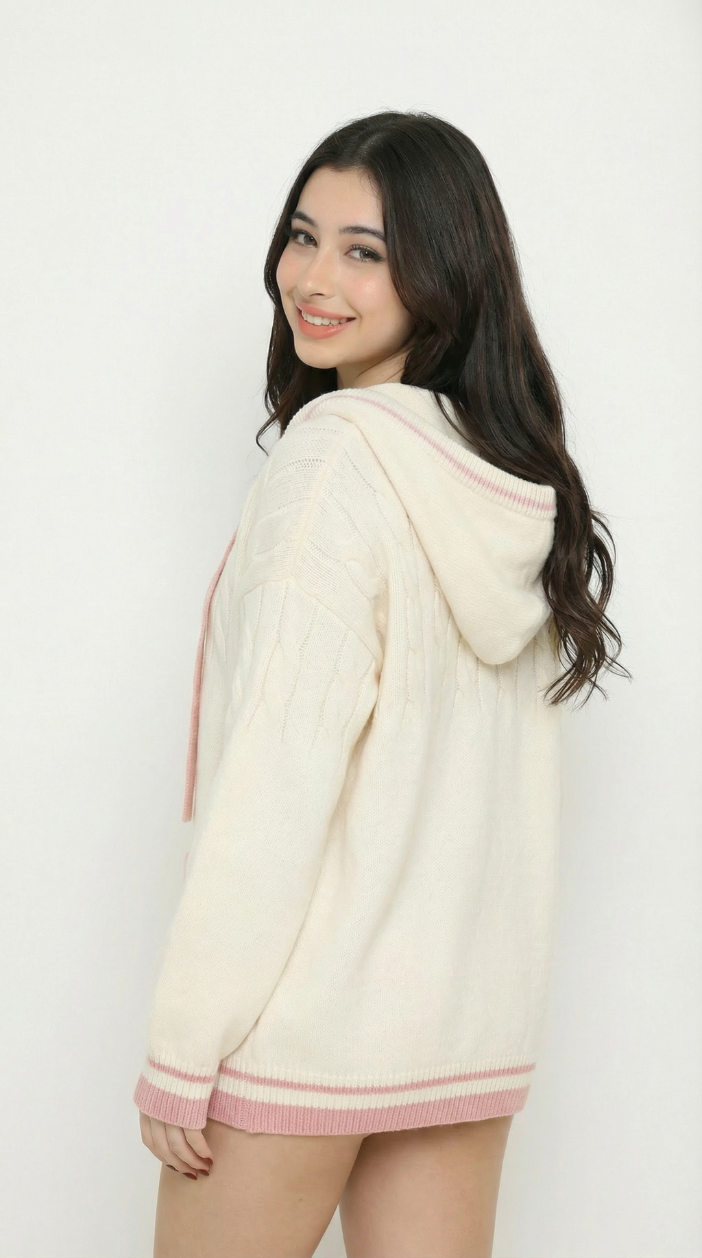 Women wearing a cream cardigan with sexy pink trim from Meleche or Meléche (short as (Mé)) on a white background