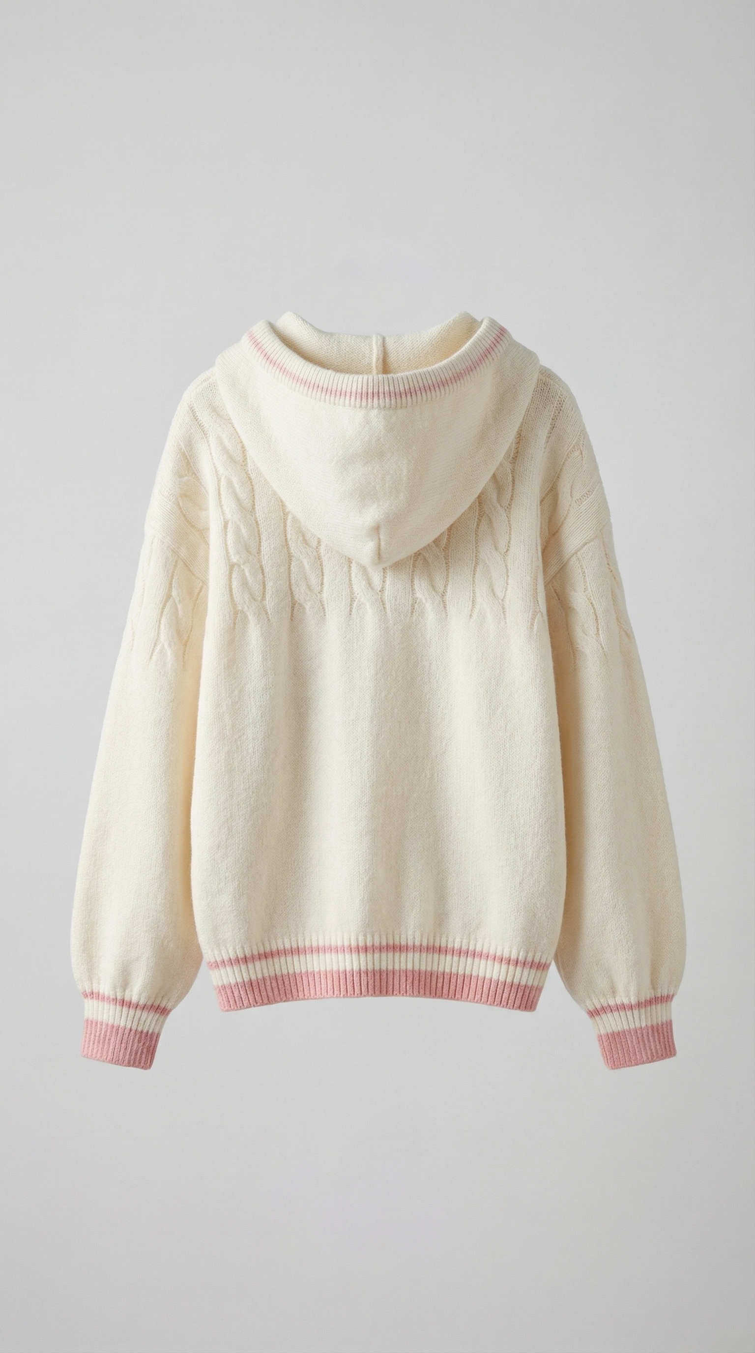 Cream-colored sweater with pink trim on a light gray background
