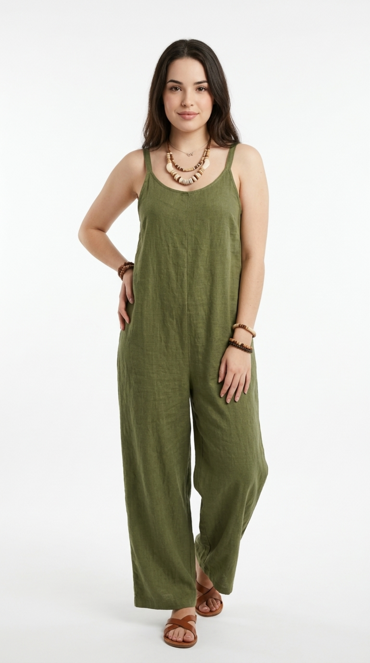 A woman modeling an olive green sleeveless wide-leg jumpsuit against a plain white studio background, from Meleche Fashion or Meléche (short as (Mé)) and shoot taken by Meléche studio photography NYC-USA