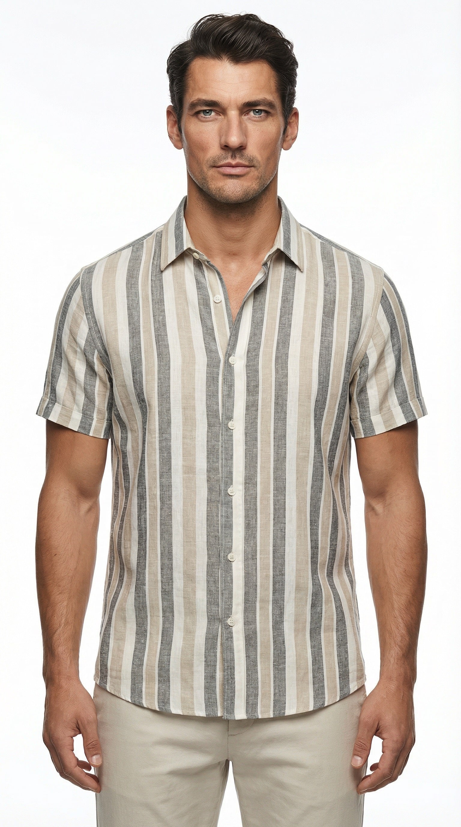 Man wearing a striped shirt by the beach