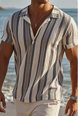Man wearing a striped shirt by the beach
