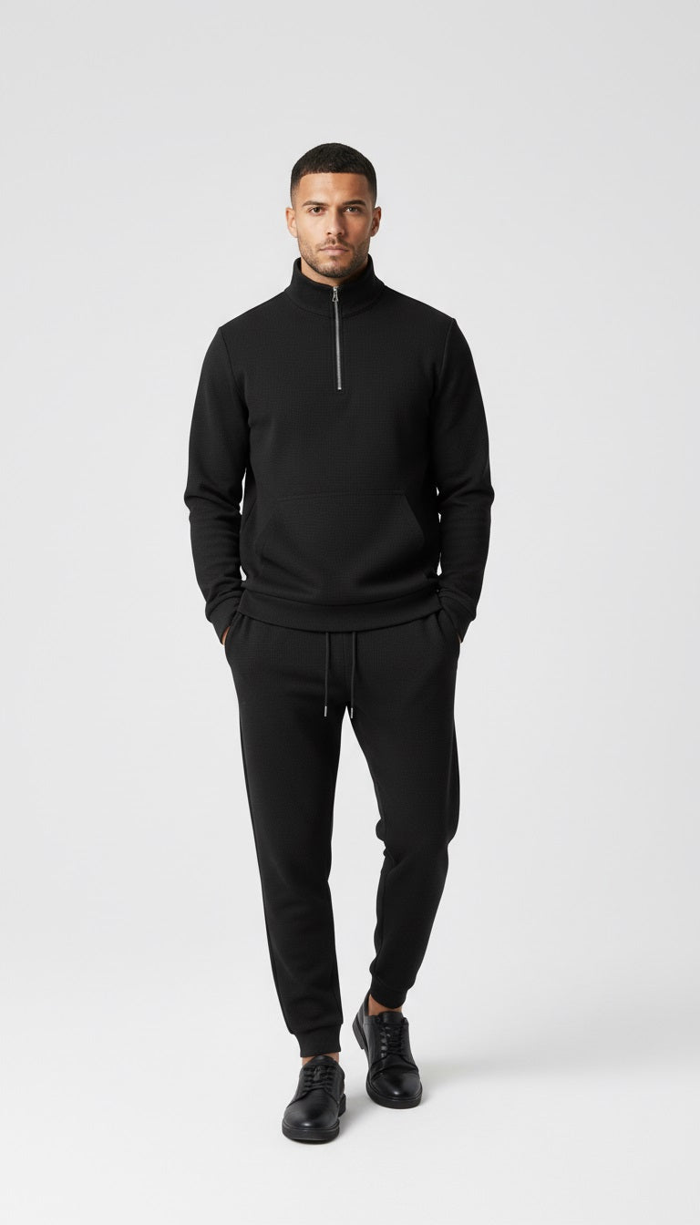 Man in black outfit walking on a city street