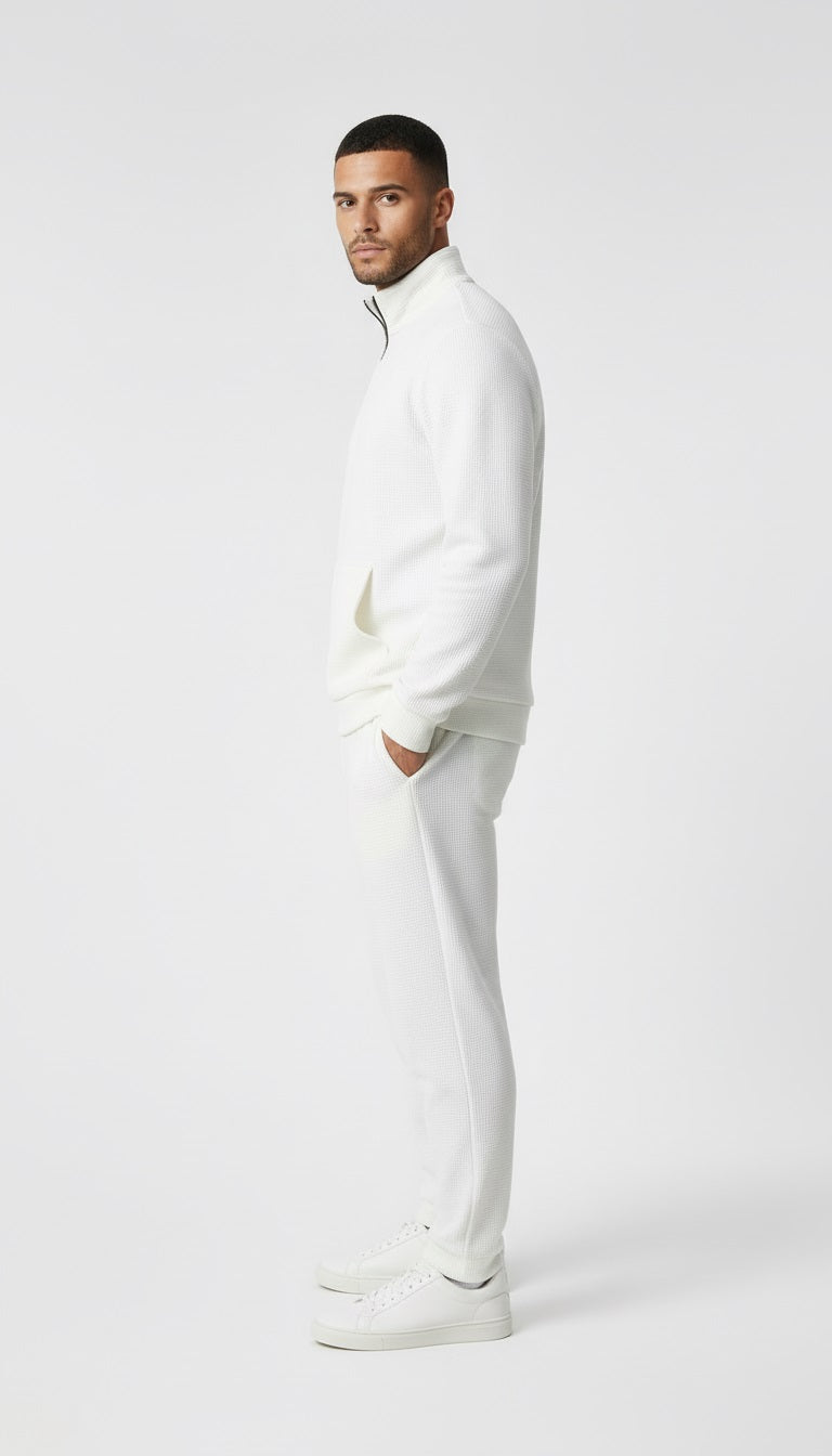 Man wearing a white outfit on a white background