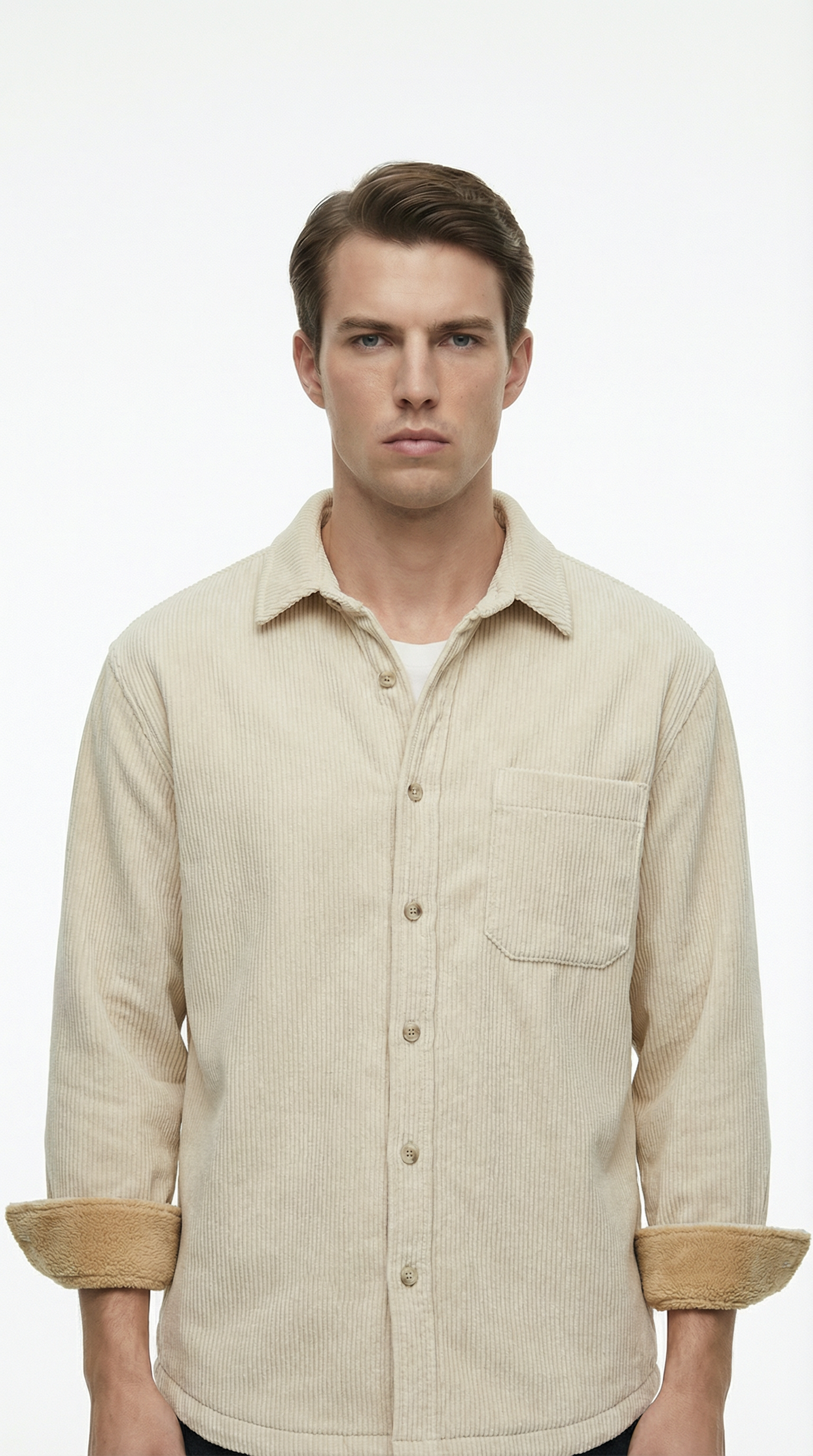 Man wearing a beige corduroy shirt with rolled-up sleeves on a white background