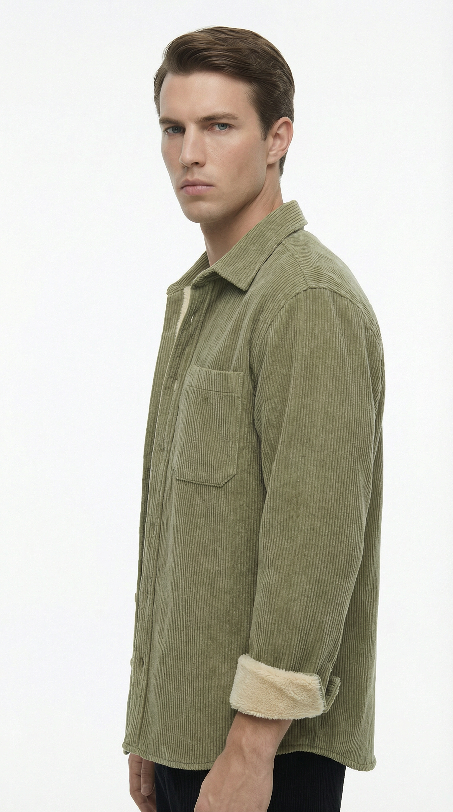 Man wearing a green corduroy shirt with beige cuffs on a white background