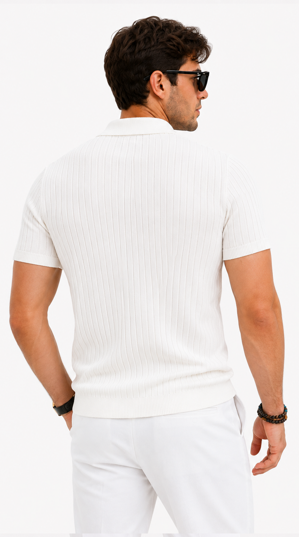 A man shown from the back wearing a white short-sleeve ribbed knit polo shirt and white trousers, with black sunglasses and bracelets, against a plain white studio background, from Meleche Fashion USA or Meléche (short as (Mé))